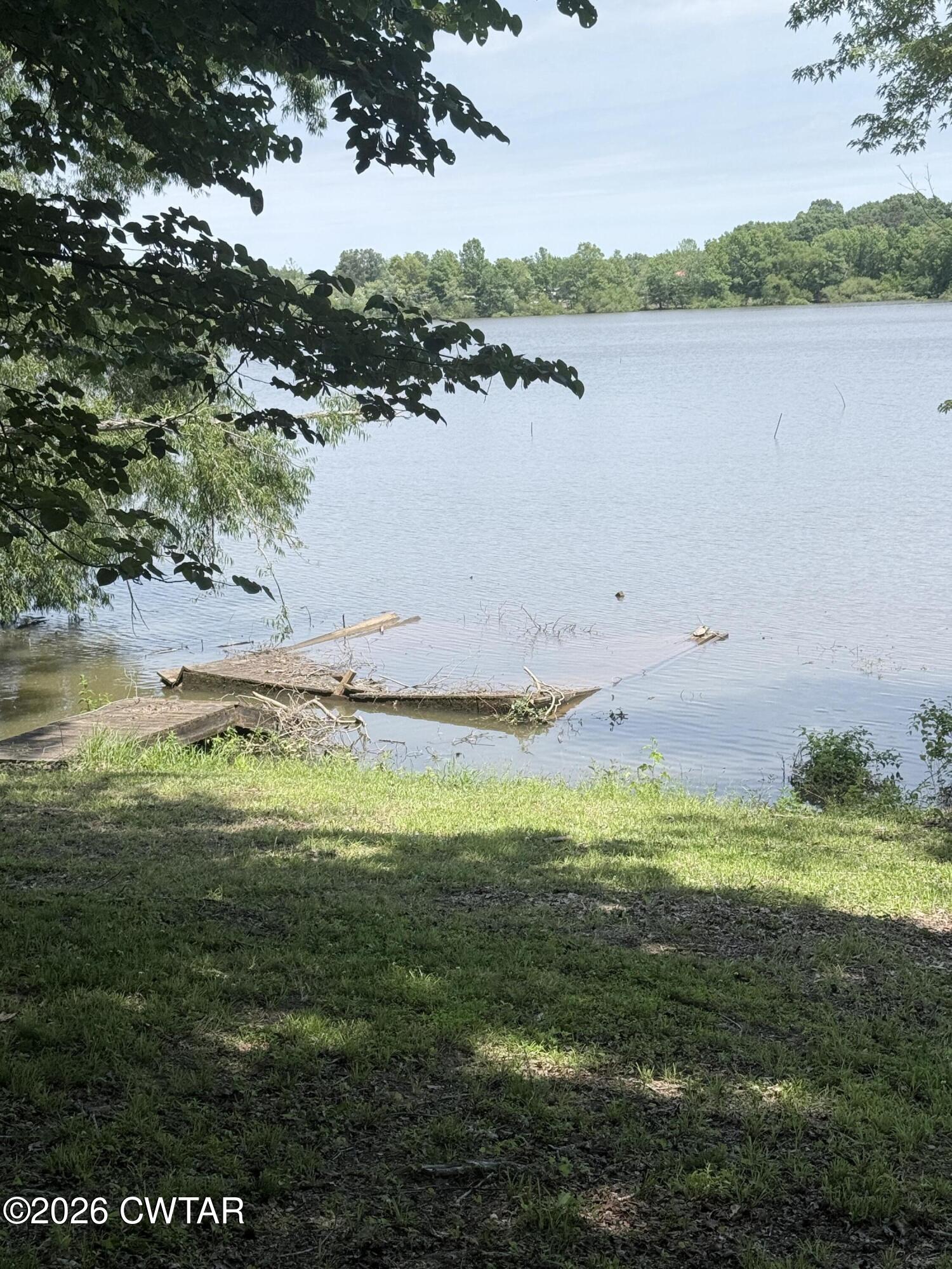 1060 Lost Creek Boat Dock Road Decaturville, TN 38329 - Photo 11 of 40 a view of a lake with a big yard
