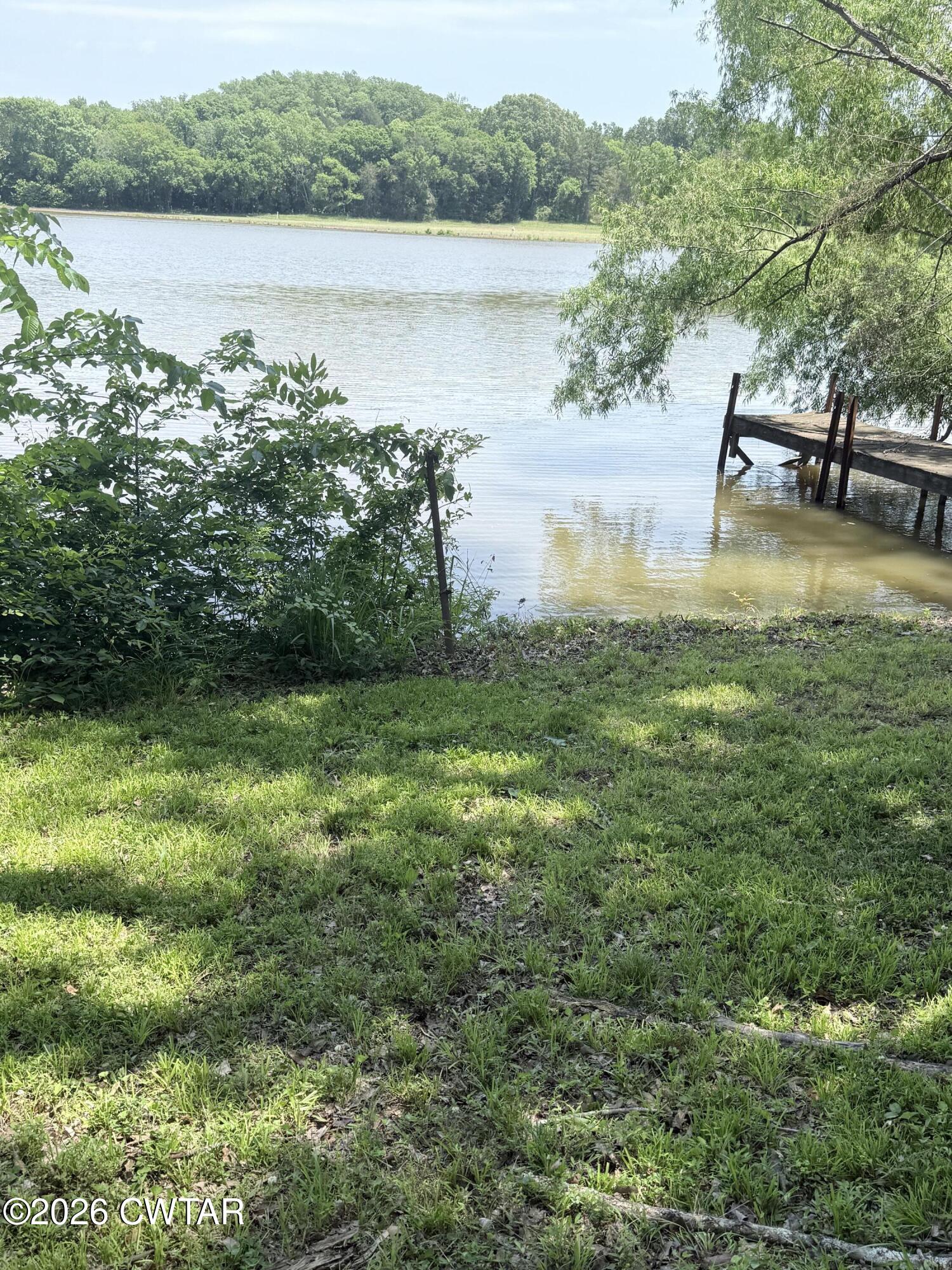 1060 Lost Creek Boat Dock Road Decaturville, TN 38329 - Photo 12 of 40 a view of a lake from a yard