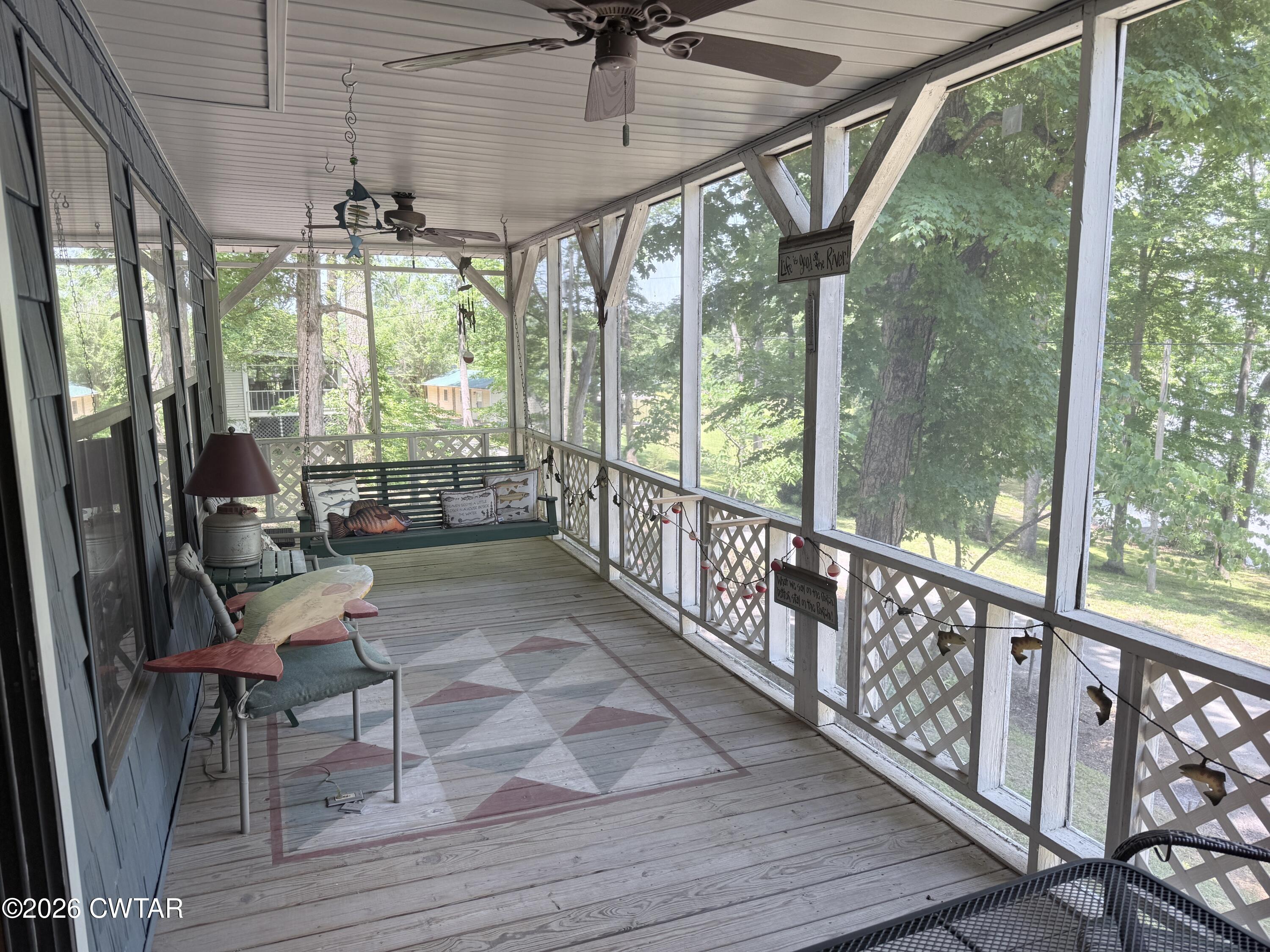 1060 Lost Creek Boat Dock Road Decaturville, TN 38329 - Photo 18 of 40 a view of a porch with furniture and wooden floor