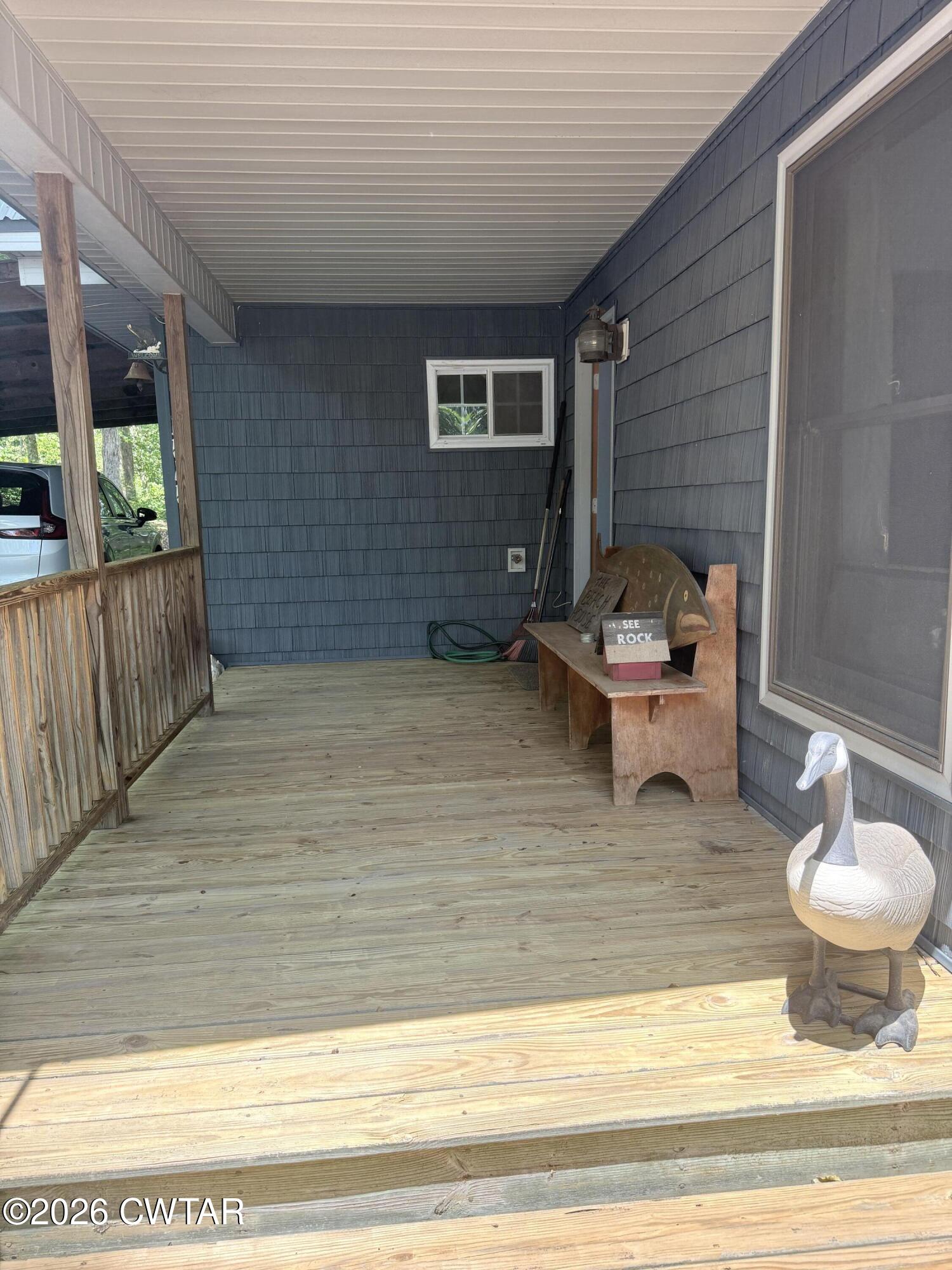 1060 Lost Creek Boat Dock Road Decaturville, TN 38329 - Photo 21 of 40 a backyard of a house with table and chairs