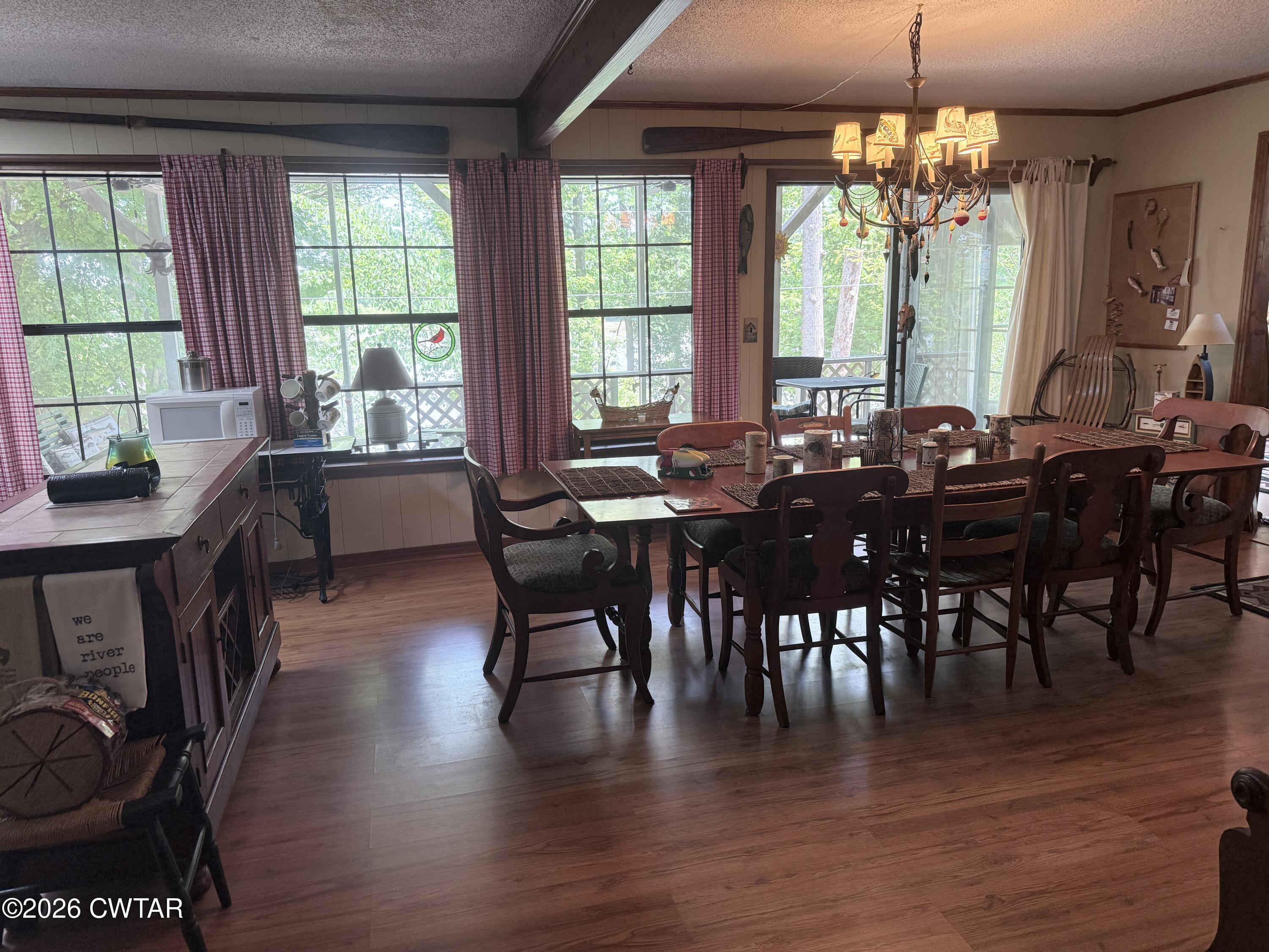 1060 Lost Creek Boat Dock Road Decaturville, TN 38329 - Photo 26 of 40 a view of a dining room with furniture window and wooden floor