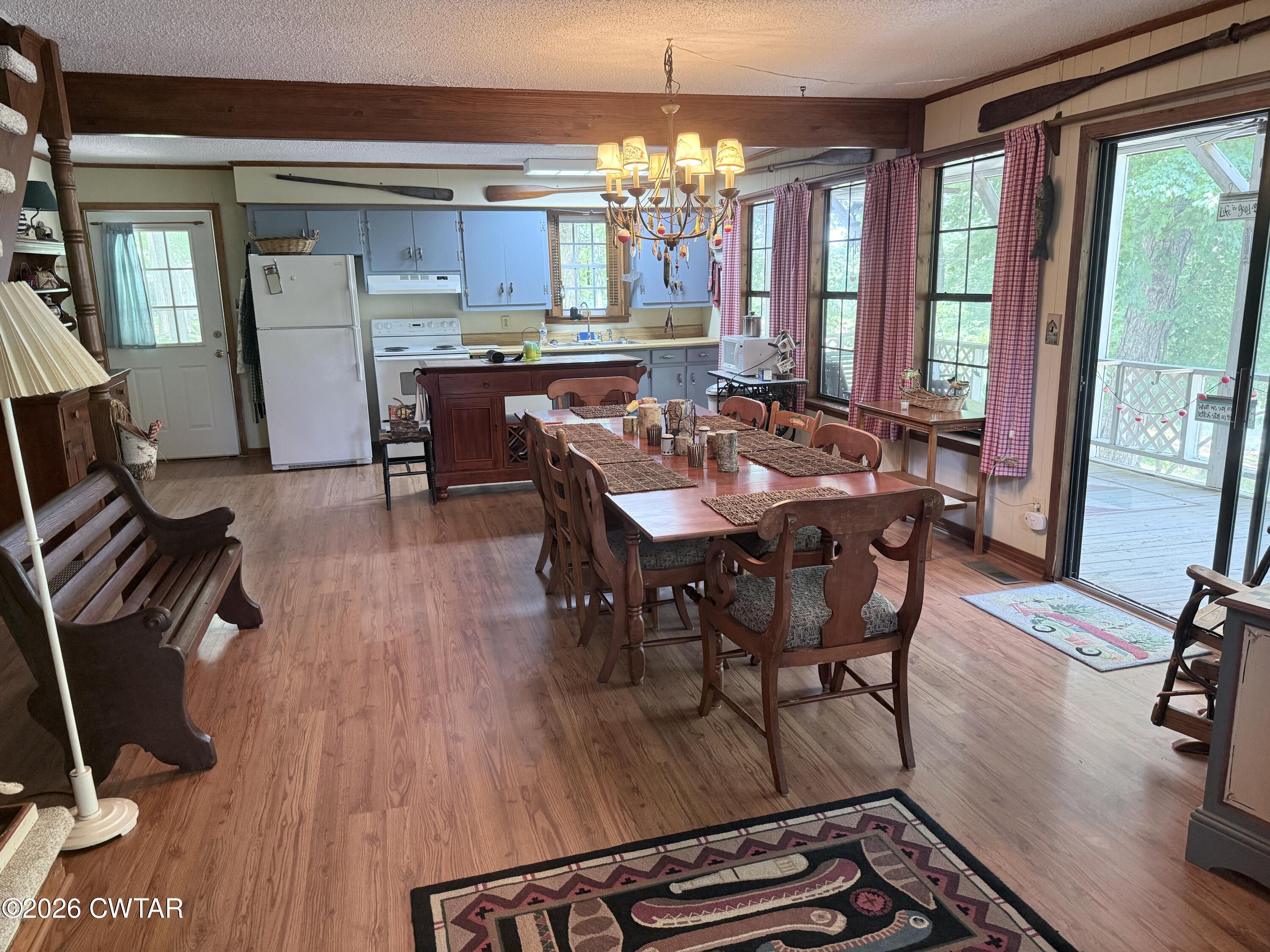 1060 Lost Creek Boat Dock Road Decaturville, TN 38329 - Photo 28 of 40 a view of a dining room with furniture a chandelier and wooden floor