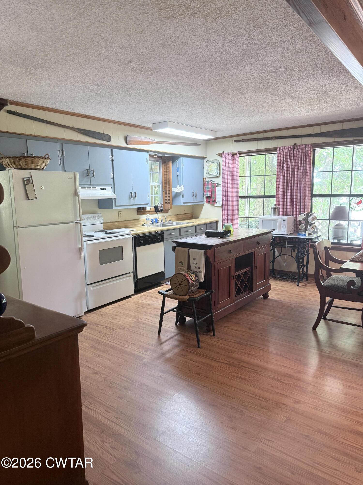 1060 Lost Creek Boat Dock Road Decaturville, TN 38329 - Photo 30 of 40 a living room with stainless steel appliances granite countertop furniture wooden floor and a window