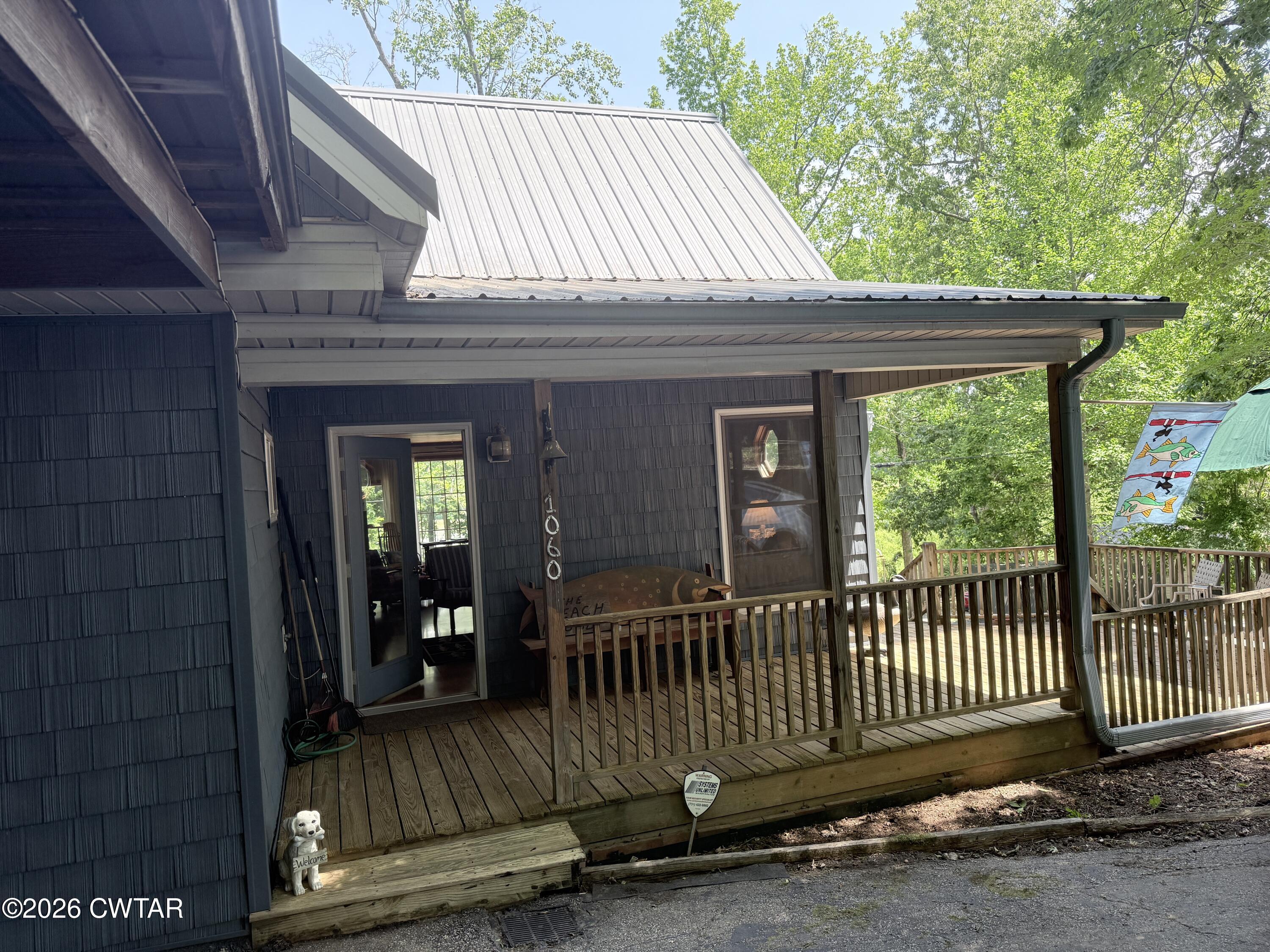 1060 Lost Creek Boat Dock Road Decaturville, TN 38329 - Photo 3 of 40 a view of a house with a porch