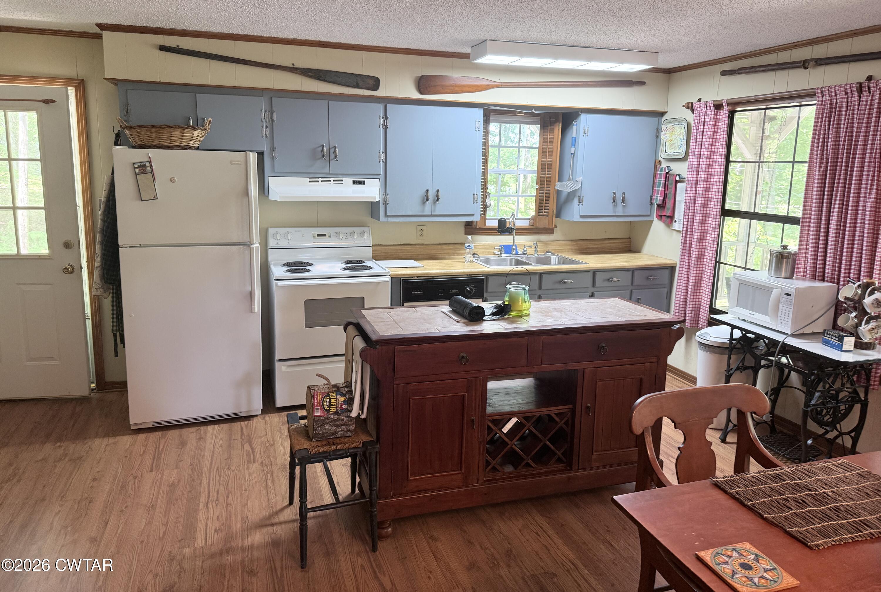 1060 Lost Creek Boat Dock Road Decaturville, TN 38329 - Photo 31 of 40 a kitchen with a refrigerator and a table chair