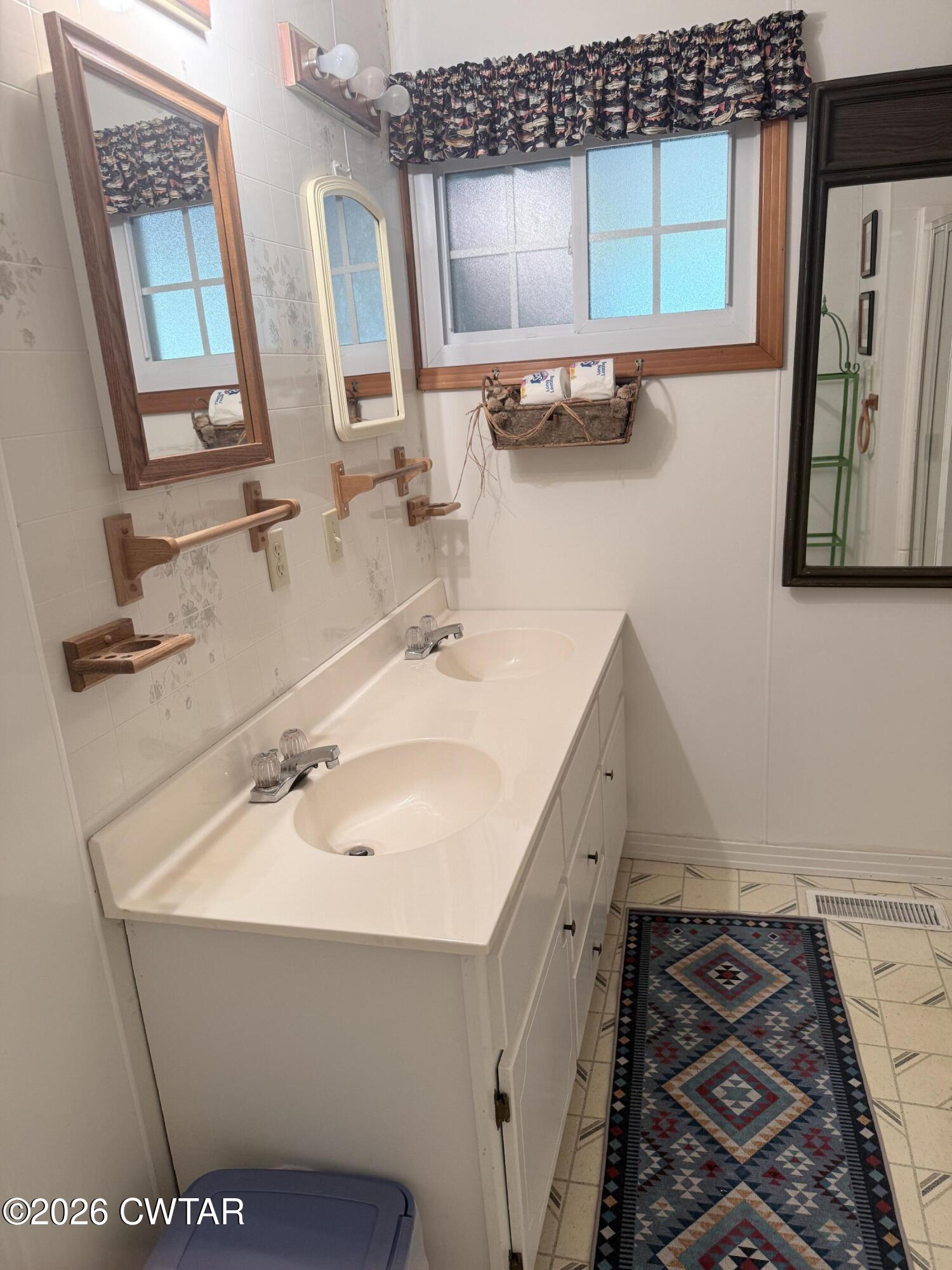 1060 Lost Creek Boat Dock Road Decaturville, TN 38329 - Photo 34 of 40 a bathroom with a sink and a mirror