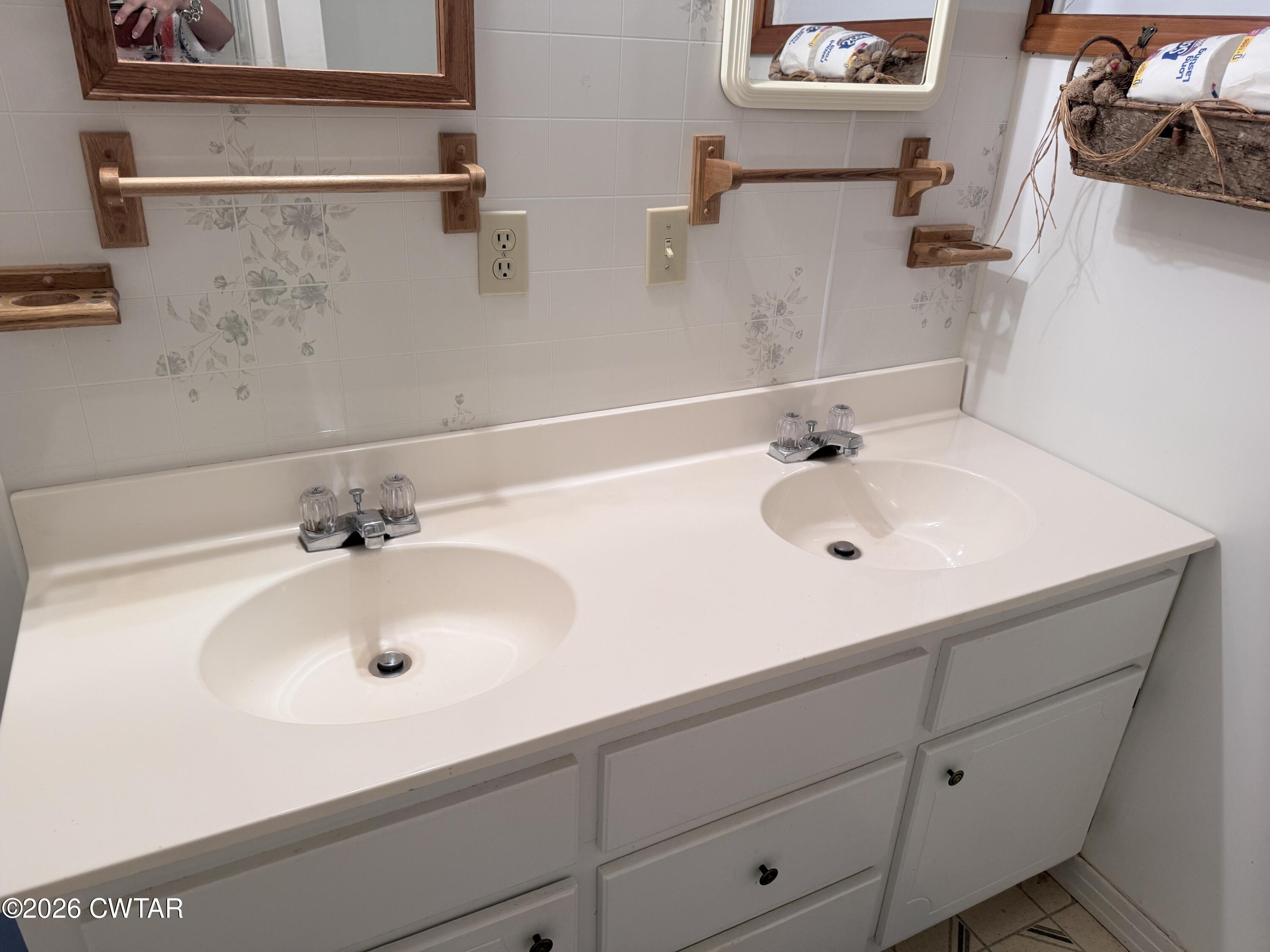 1060 Lost Creek Boat Dock Road Decaturville, TN 38329 - Photo 35 of 40 a bathroom with a sink and a white cabinet