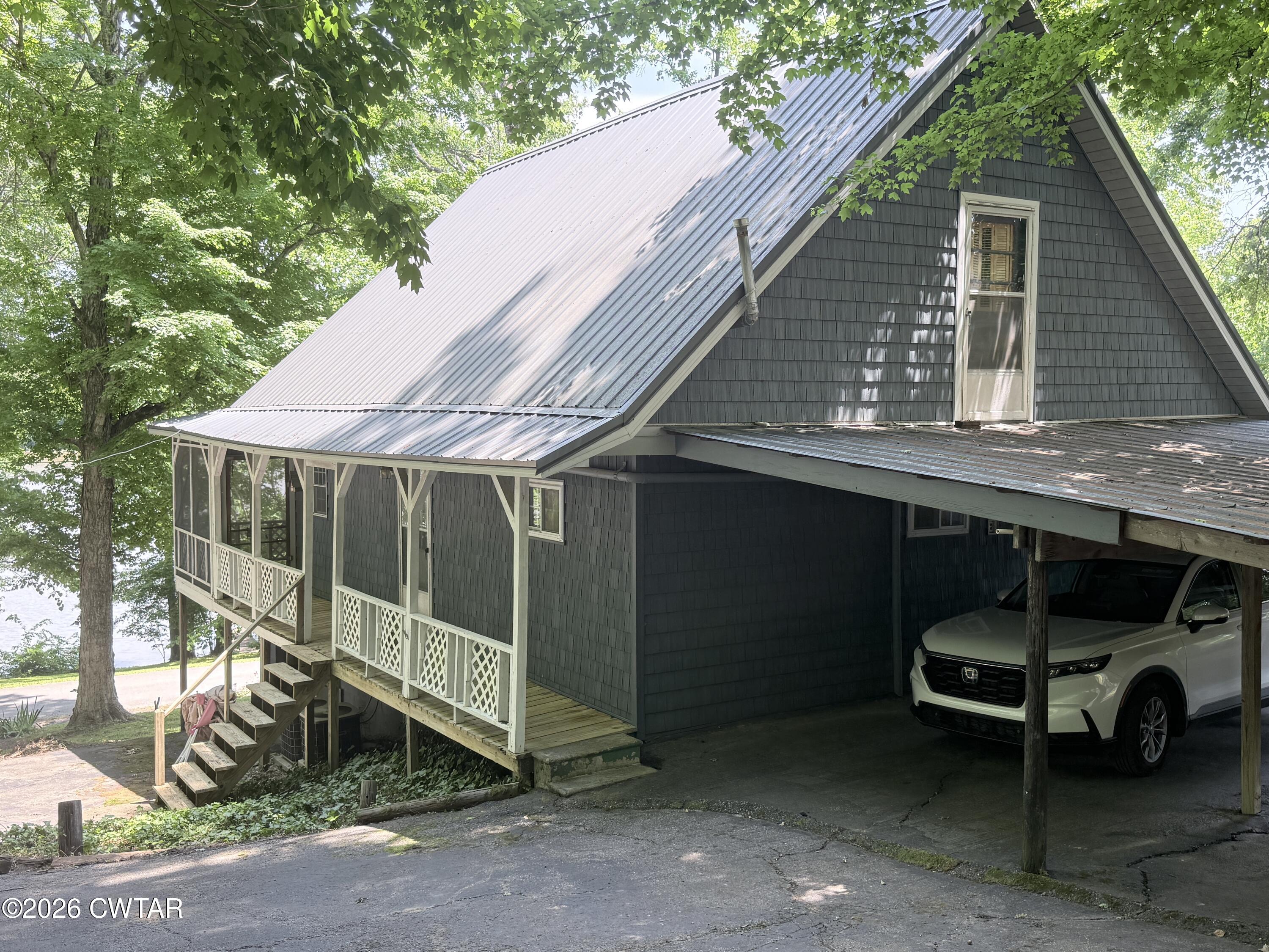 1060 Lost Creek Boat Dock Road Decaturville, TN 38329 - Photo 4 of 40 a backyard of a house with barbeque oven and table