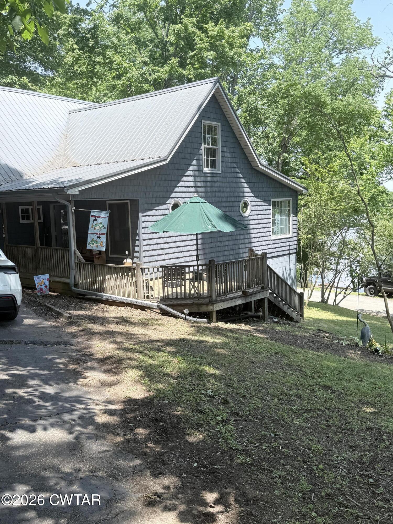 1060 Lost Creek Boat Dock Road Decaturville, TN 38329 - Photo 5 of 40 a front view of a house with garden