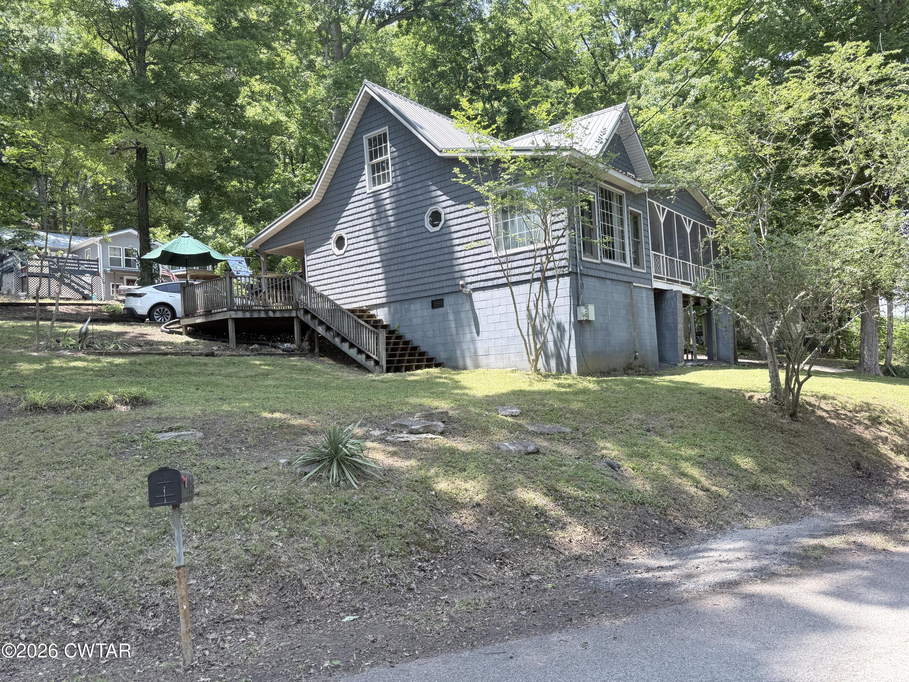 1060 Lost Creek Boat Dock Road Decaturville, TN 38329 - Photo 6 of 40 a view of a house with a yard