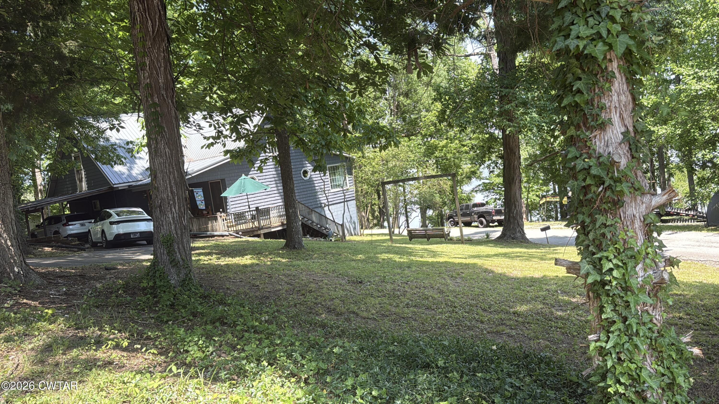 1060 Lost Creek Boat Dock Road Decaturville, TN 38329 - Photo 9 of 40 a view of a trees in front of a house