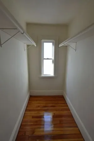 a view of room with window and hardwood floor
