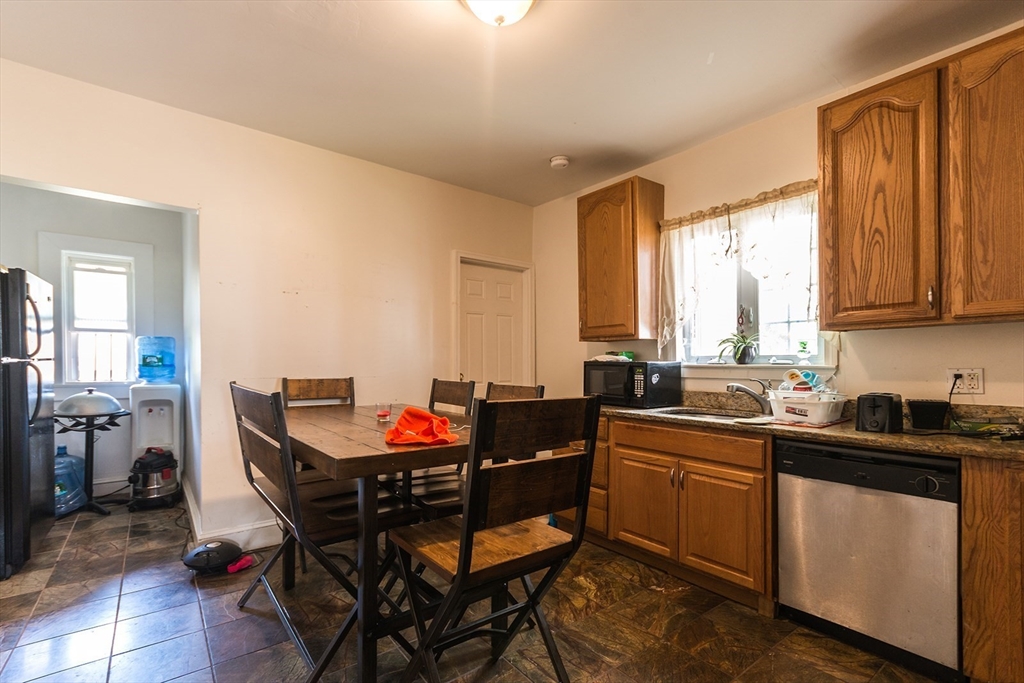 7 Topliff Street, Unit 1 Boston, MA 02122 - Photo 2 of 25 a kitchen with a sink stove and dining table