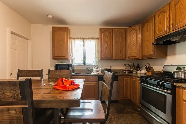 a kitchen with a stove a sink and a microwave