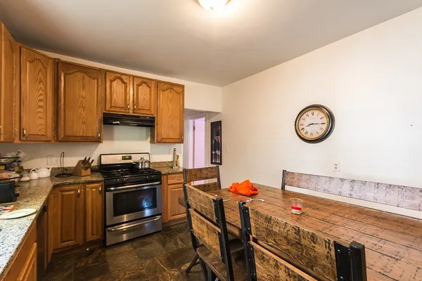 a kitchen with a stove and a refrigerator