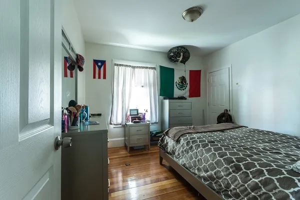 a bedroom with a bed and a dresser