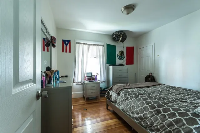 a bedroom with a bed and a dresser