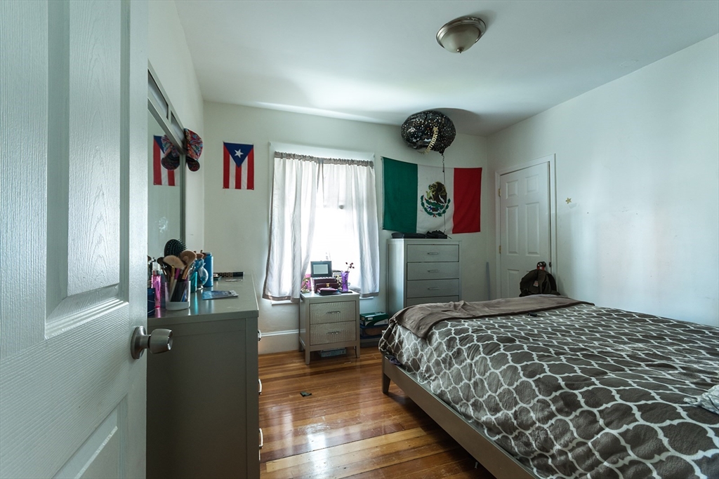 7 Topliff Street, Unit 1 Boston, MA 02122 - Photo 9 of 25 a bedroom with a bed and a dresser