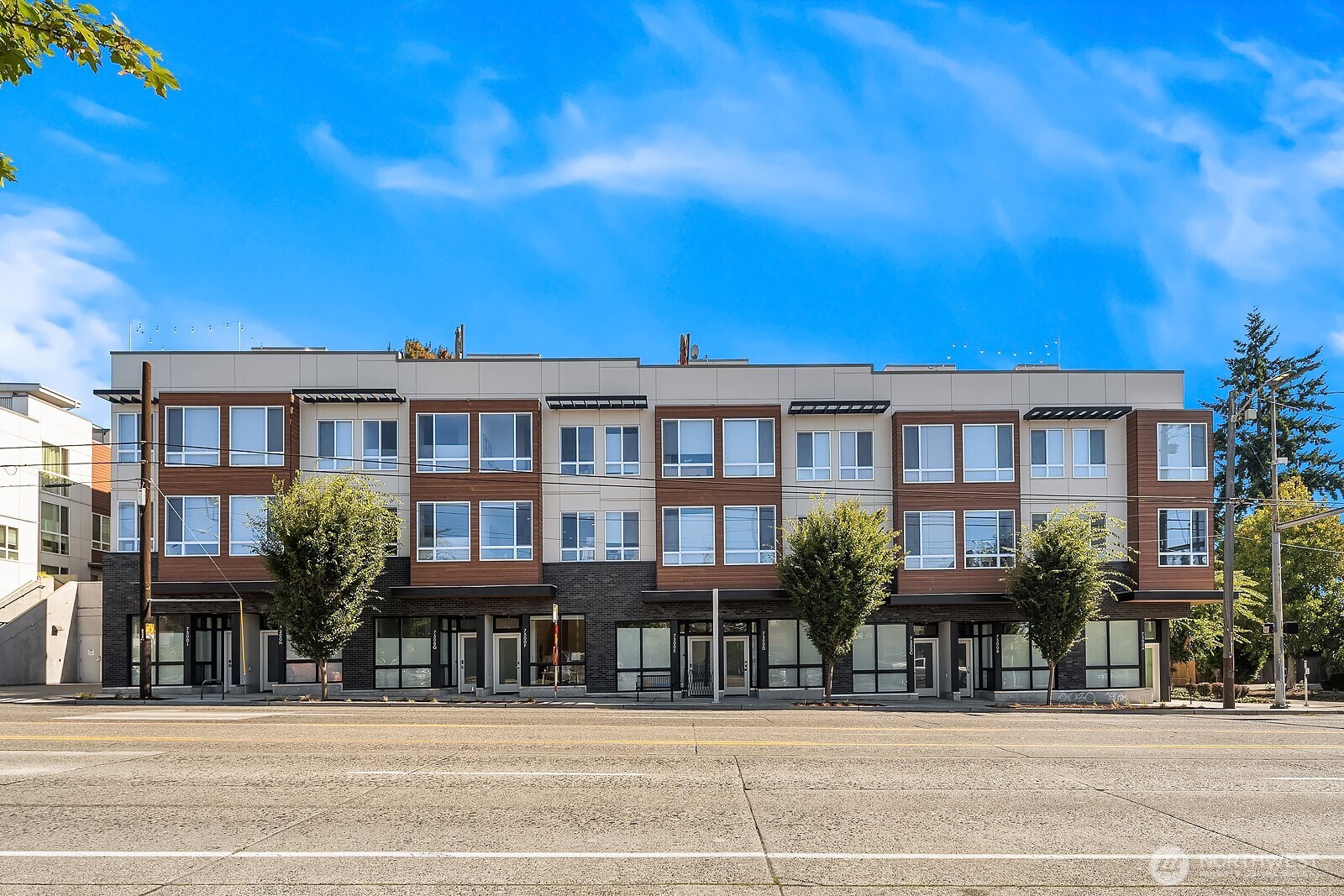 7500 15th Avenue Northwest, Unit F Seattle, WA 98117 - Photo 1 of 1 a front view of a building and a garden