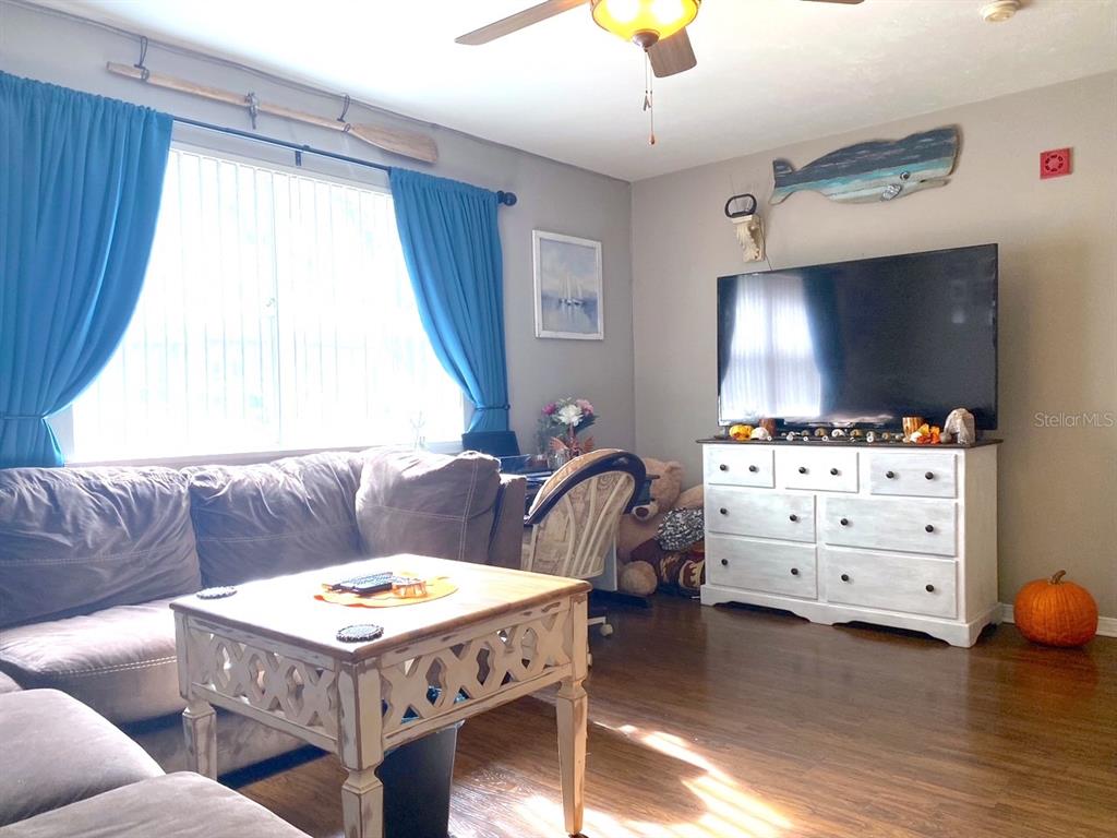 a living room with furniture and a flat screen tv