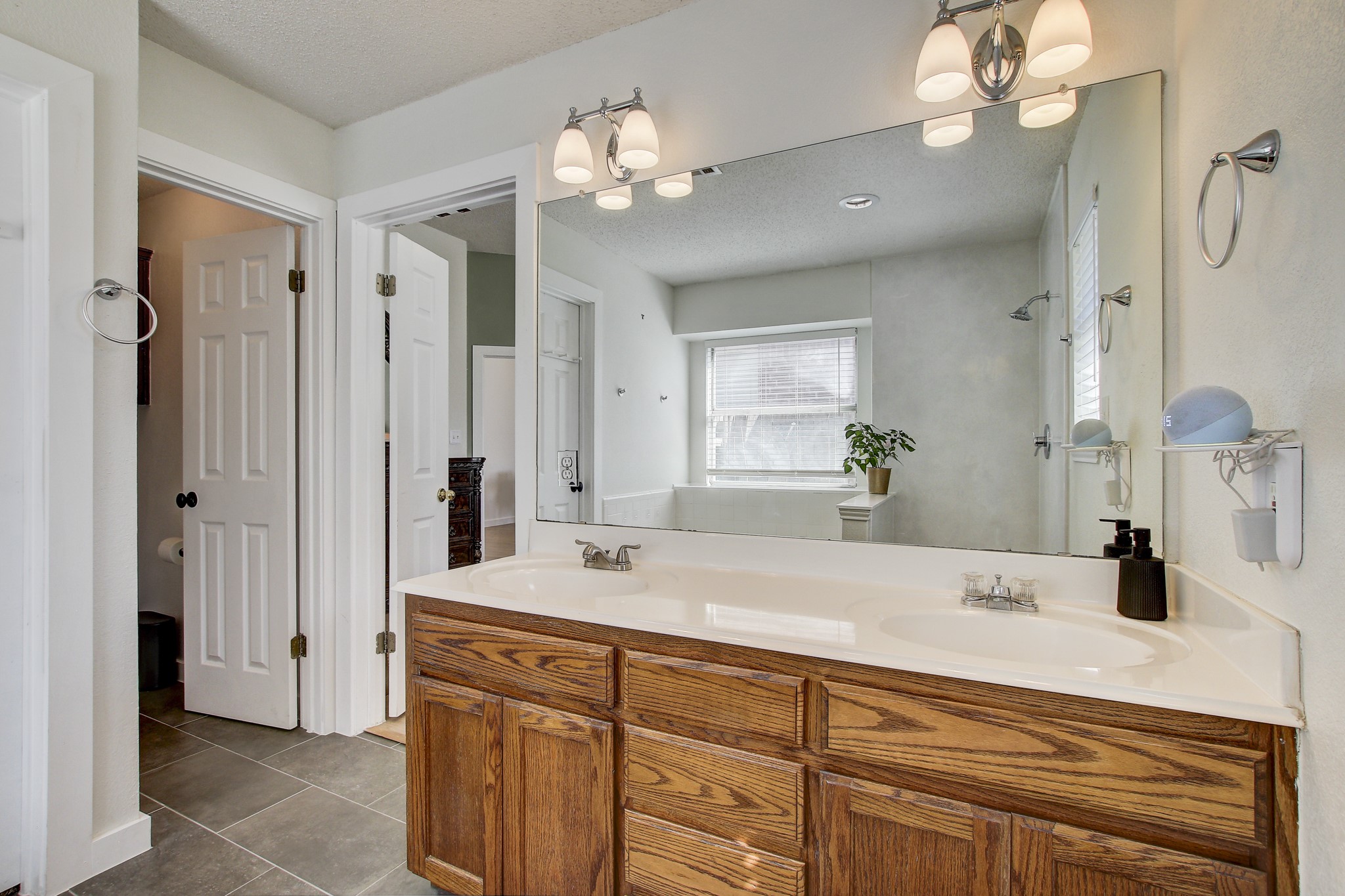 806 Ridge View Drive Leander, TX 78641 - Photo 20 of 30 a bathroom with a sink a vanity a lamp and a mirror