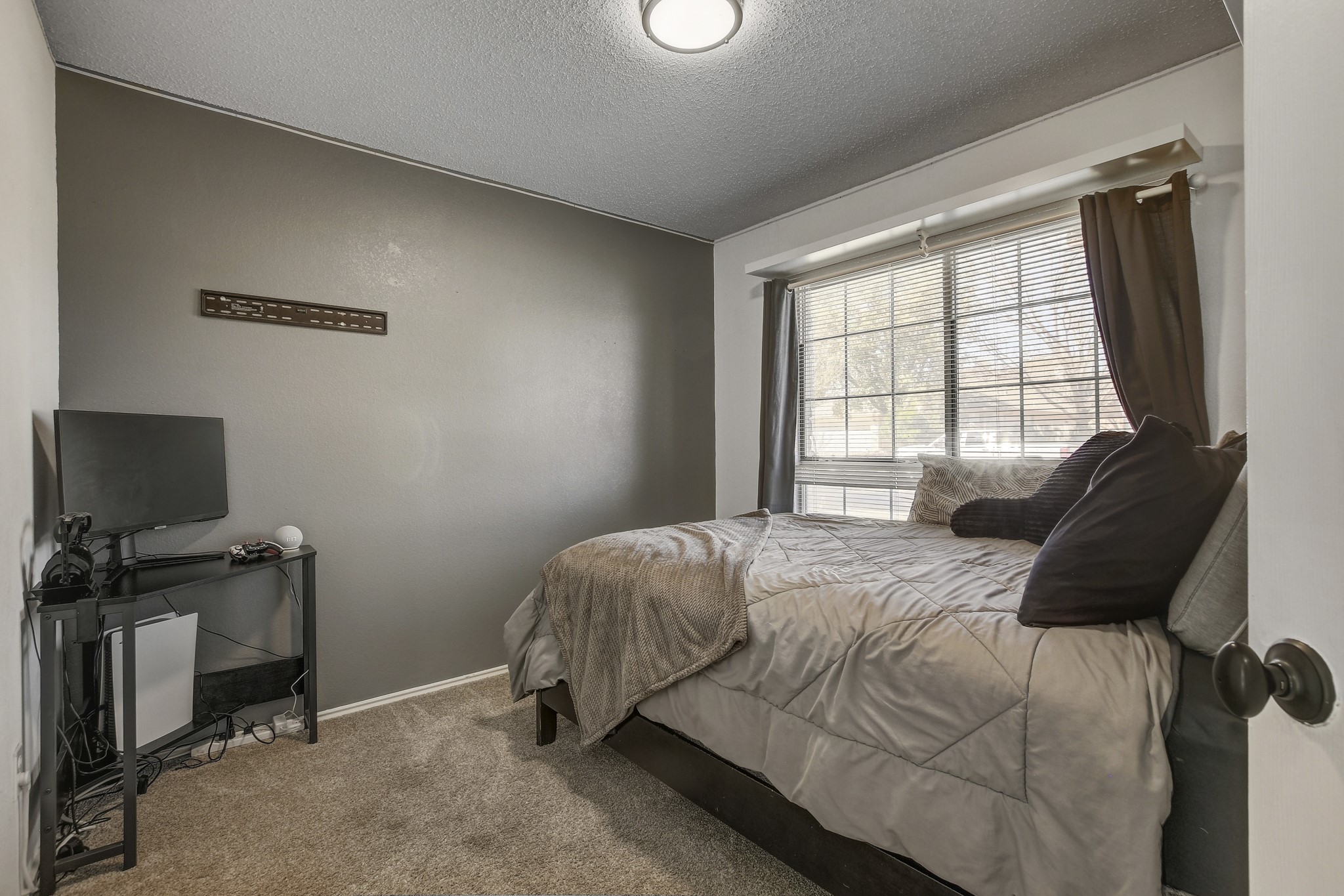 806 Ridge View Drive Leander, TX 78641 - Photo 22 of 30 a bedroom with a bed and a flat screen tv