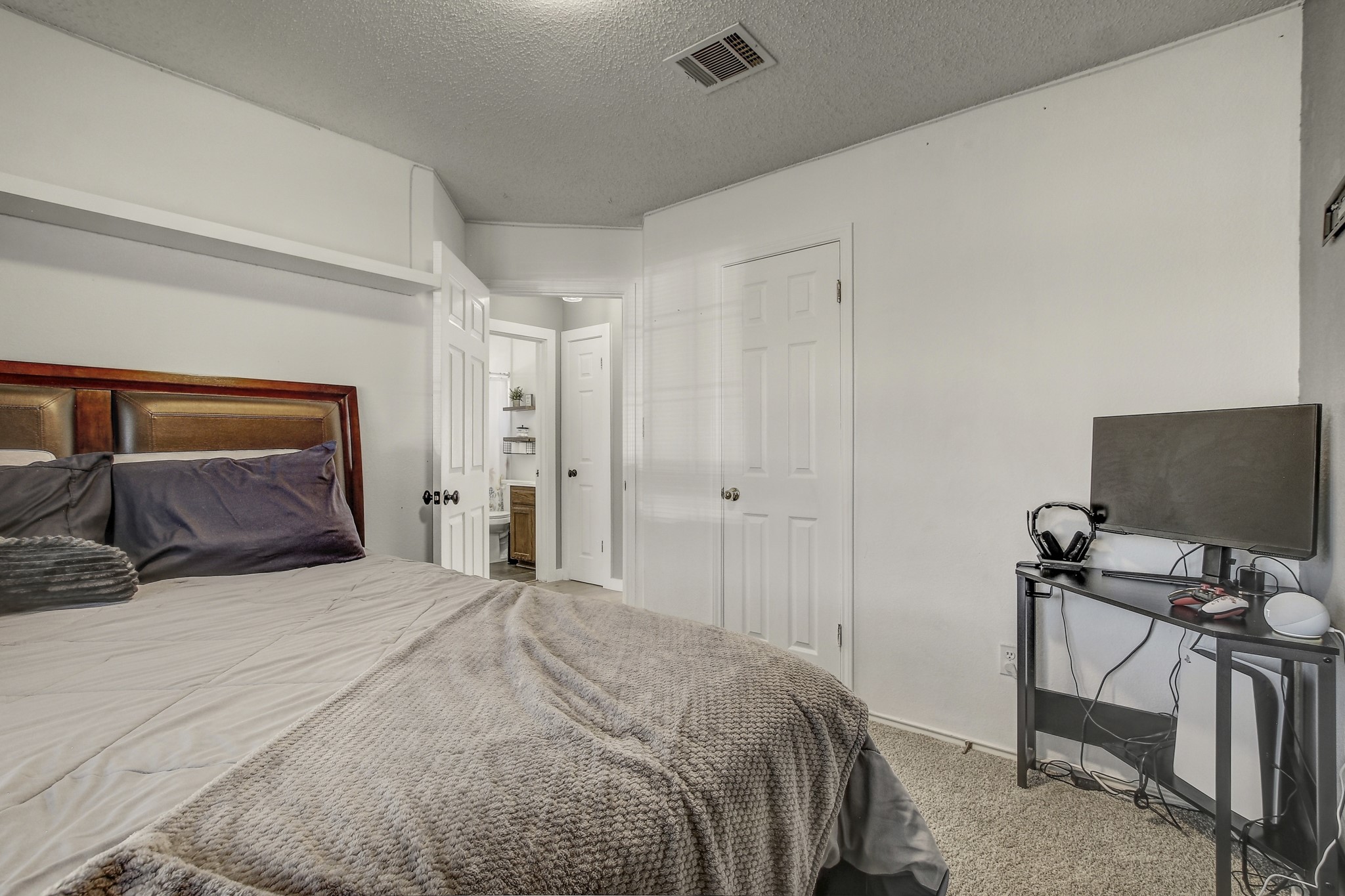 806 Ridge View Drive Leander, TX 78641 - Photo 23 of 30 a bedroom with a bed and a flat screen tv
