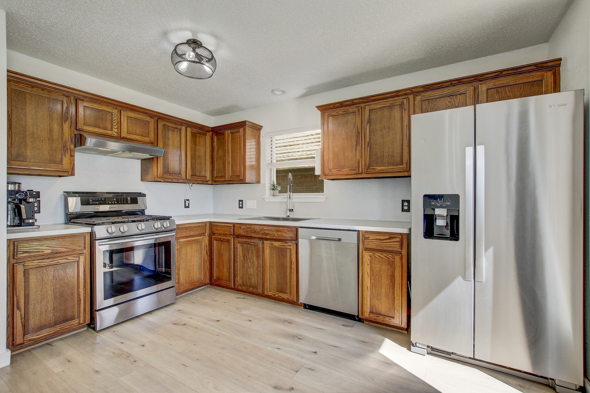 806 Ridge View Drive Leander, TX 78641 - Photo 4 of 30 a kitchen with stainless steel appliances granite countertop a refrigerator sink and cabinets