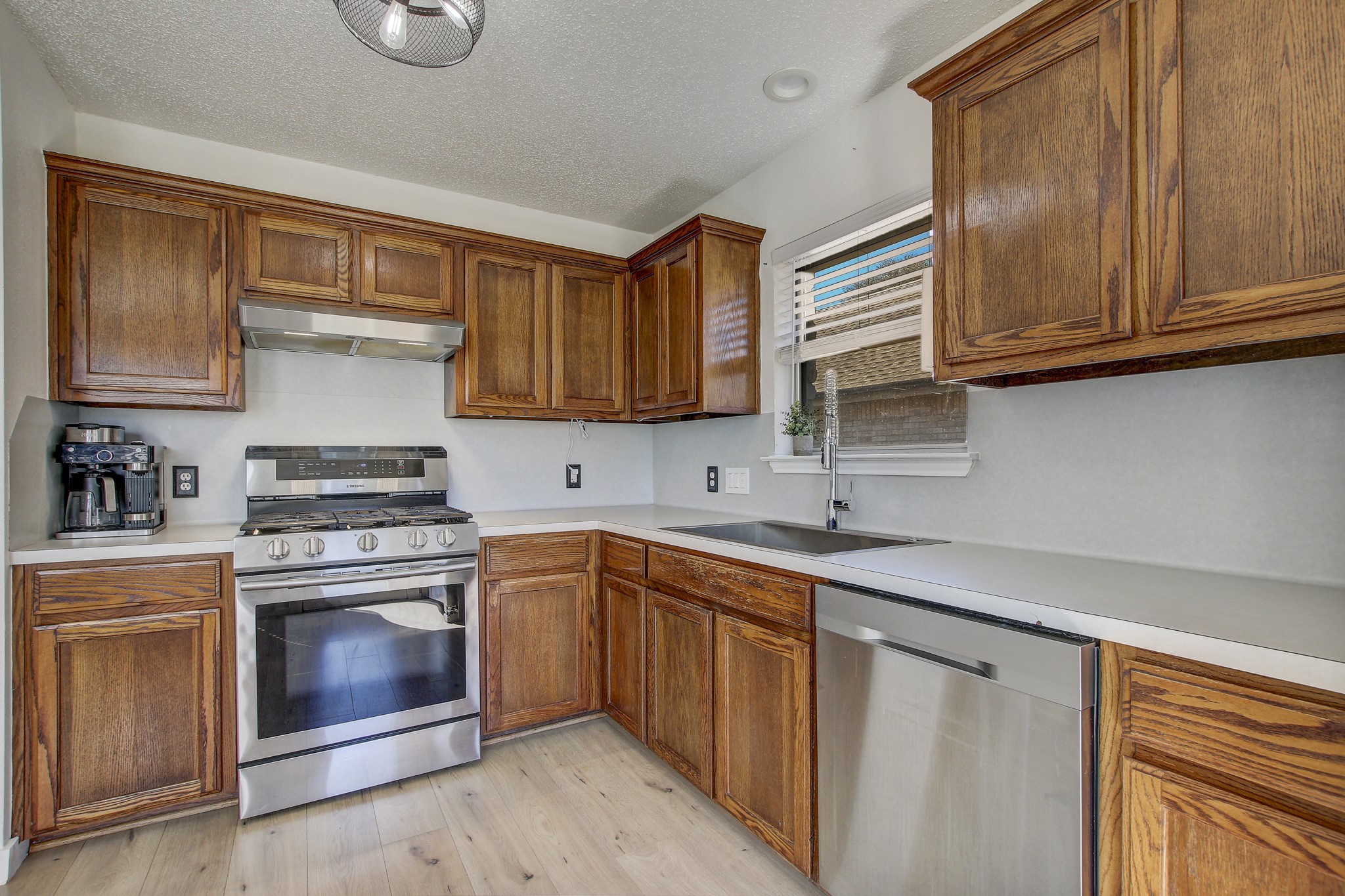 806 Ridge View Drive Leander, TX 78641 - Photo 6 of 30 a kitchen with stainless steel appliances granite countertop a sink stove and microwave