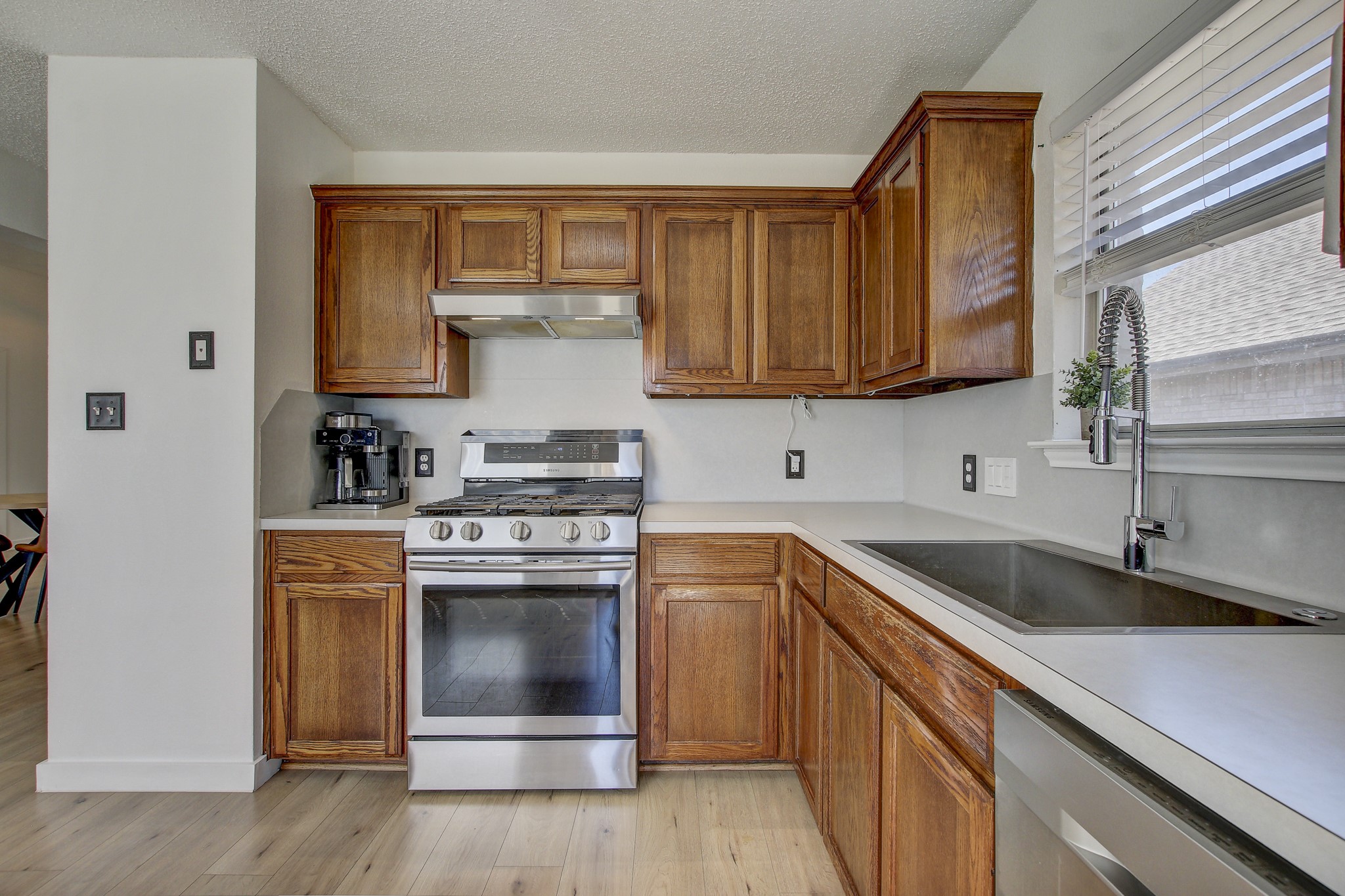 806 Ridge View Drive Leander, TX 78641 - Photo 7 of 30 a kitchen with stainless steel appliances granite countertop a sink stove and refrigerator
