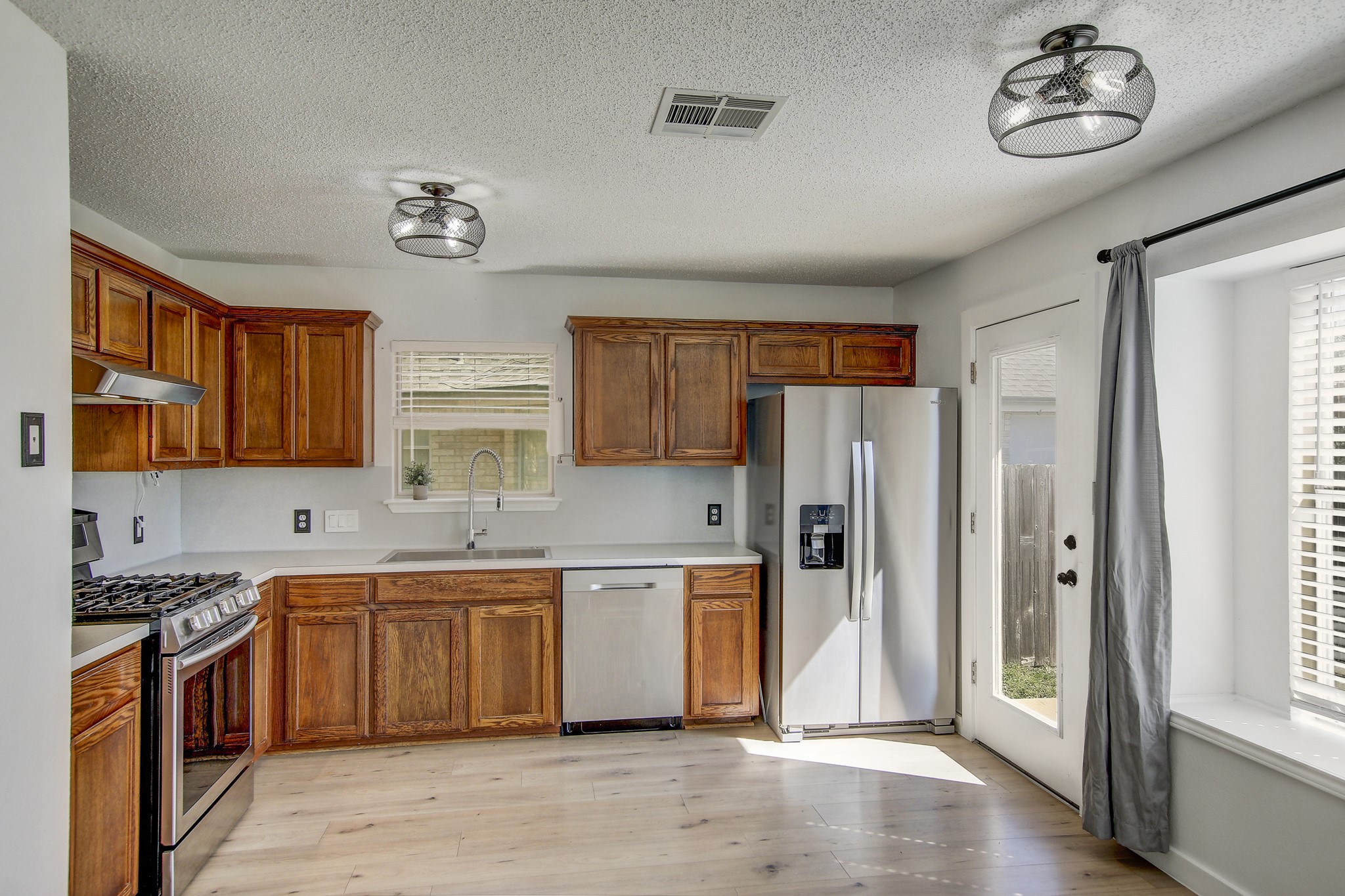 806 Ridge View Drive Leander, TX 78641 - Photo 8 of 30 a kitchen with stainless steel appliances granite countertop a refrigerator and a sink