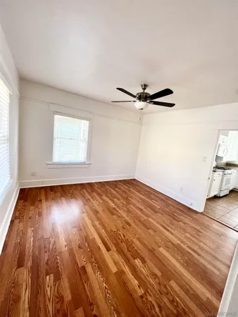 wooden floor in an empty room with a window