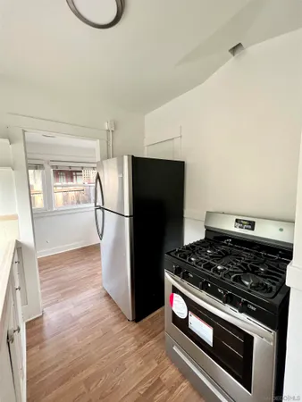 a kitchen with a stove and a refrigerator