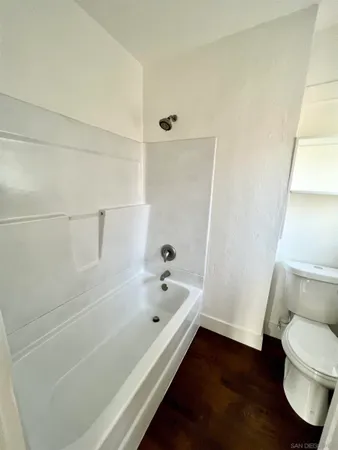 a bathroom with a bathtub and toilet