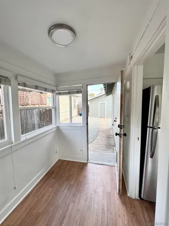 a view of a room with wooden floor and window