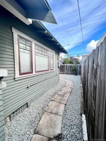 a view of a house with a wooden fence