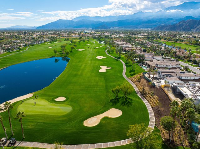 an aerial view of a golf course with a swimming pool