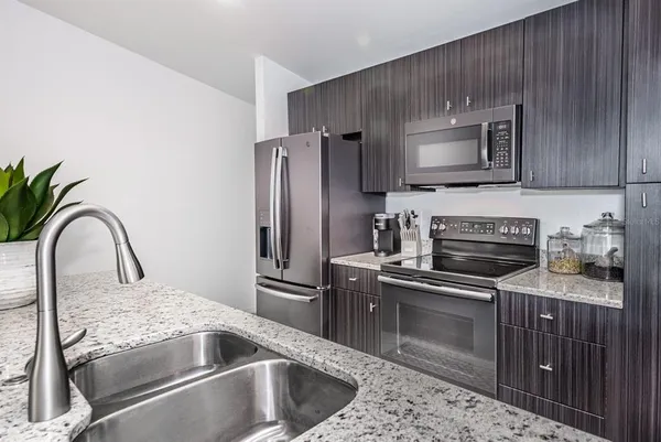 a kitchen with a sink stove and refrigerator