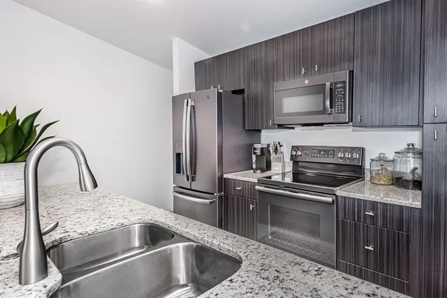 a kitchen with a sink stove and refrigerator