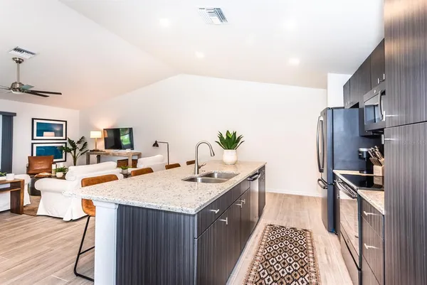 a kitchen with a sink stove and refrigerator