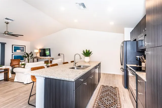 a kitchen with a sink stove and refrigerator