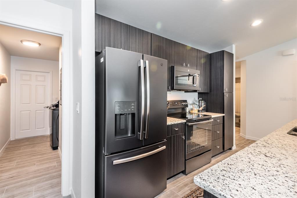 215 Lewis Circle, Unit 111 Punta Gorda, FL 33950 - Photo 15 of 43 a kitchen with stainless steel appliances granite countertop a refrigerator and a sink