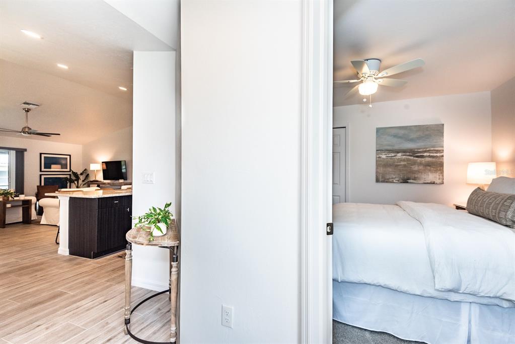 215 Lewis Circle, Unit 111 Punta Gorda, FL 33950 - Photo 17 of 43 a bedroom with a bed and a chandelier