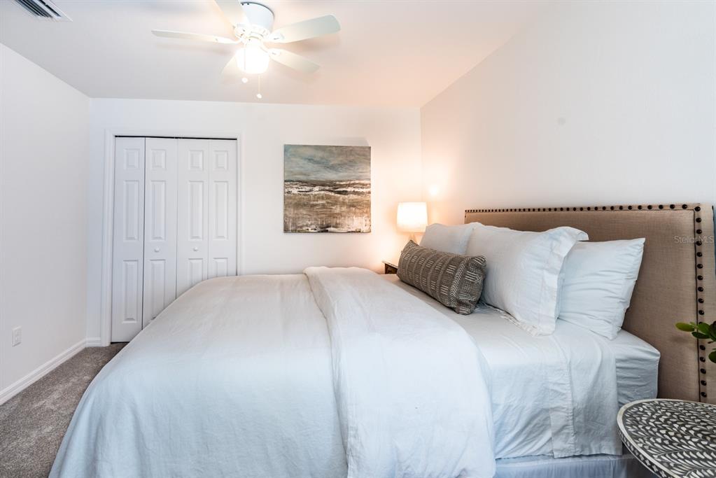 215 Lewis Circle, Unit 111 Punta Gorda, FL 33950 - Photo 18 of 43 a bedroom with a bed and a chandelier