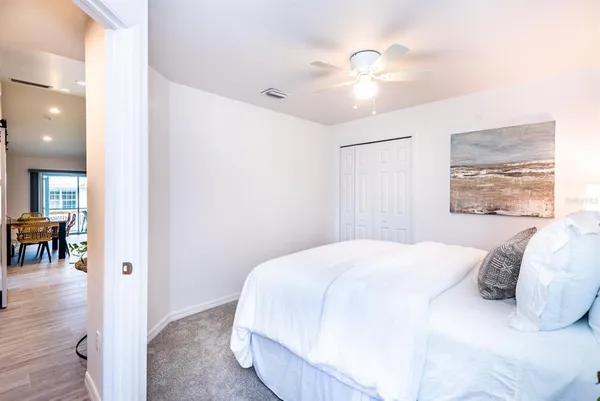 a bedroom with a large bed and a chandelier