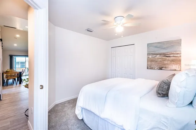 a bedroom with a large bed and a chandelier