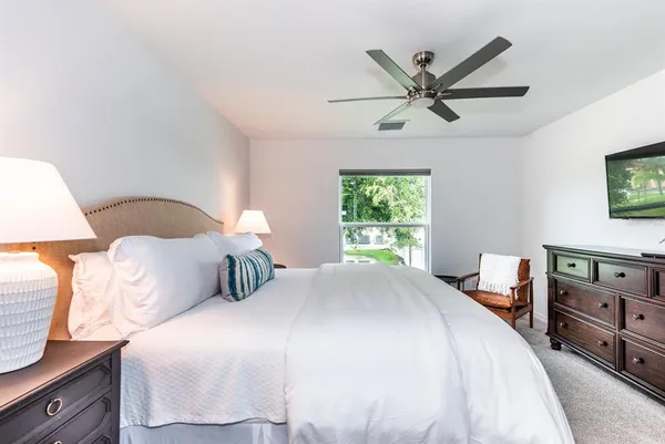 a bedroom with a bed and window