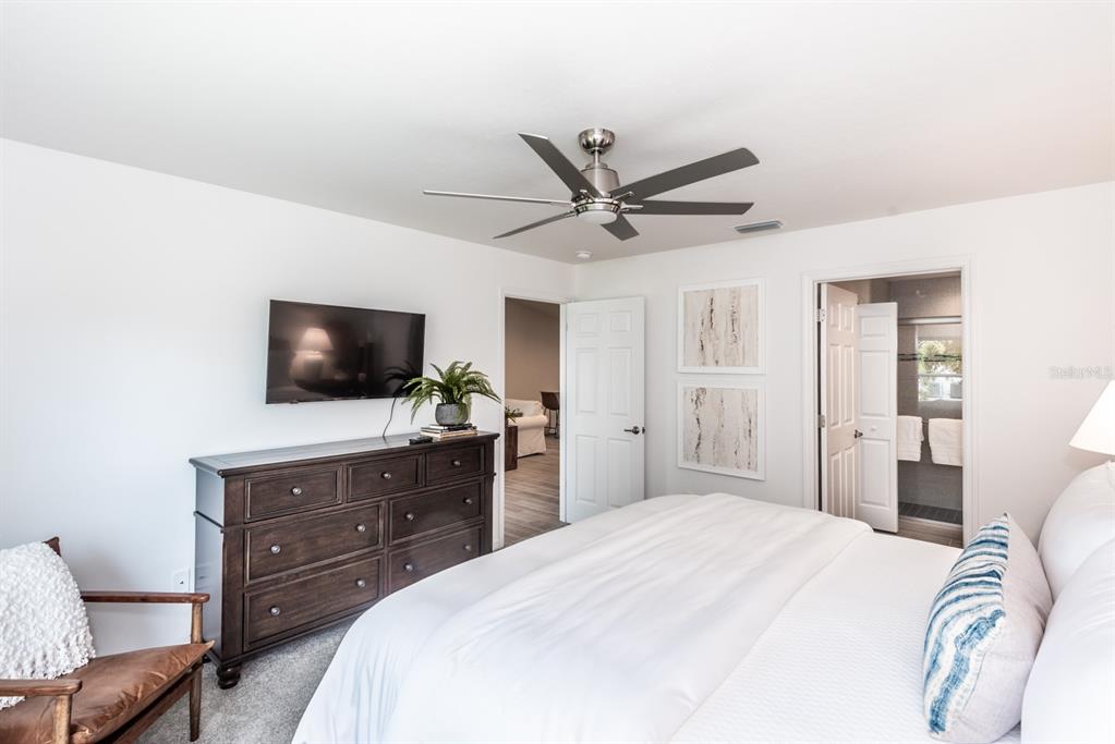 215 Lewis Circle, Unit 111 Punta Gorda, FL 33950 - Photo 31 of 43 a bedroom with a bed and a flat screen tv