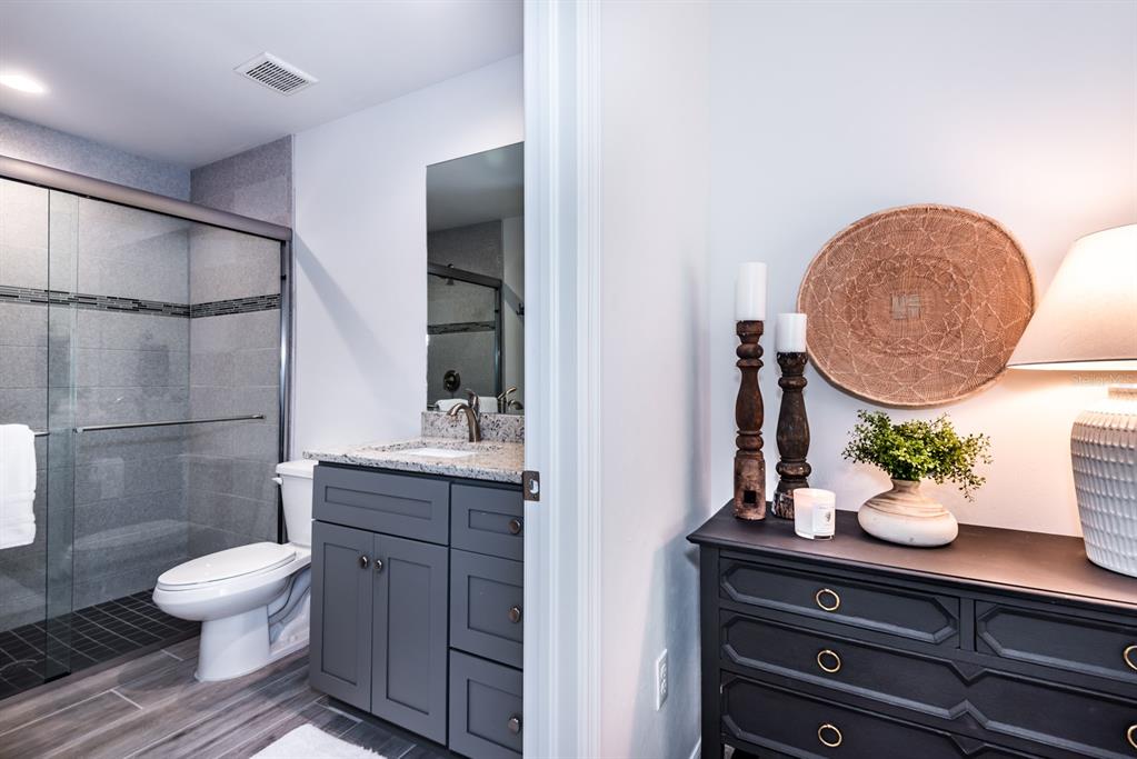 215 Lewis Circle, Unit 111 Punta Gorda, FL 33950 - Photo 32 of 43 a bathroom with a toilet sink and mirror