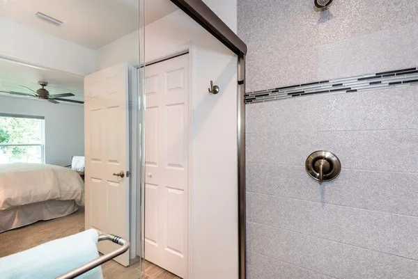 a bathroom with a glass shower door